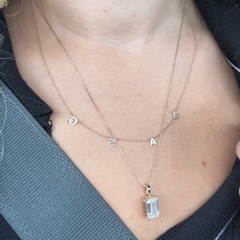 Gold Initial Necklace with “ D A S G” initials.